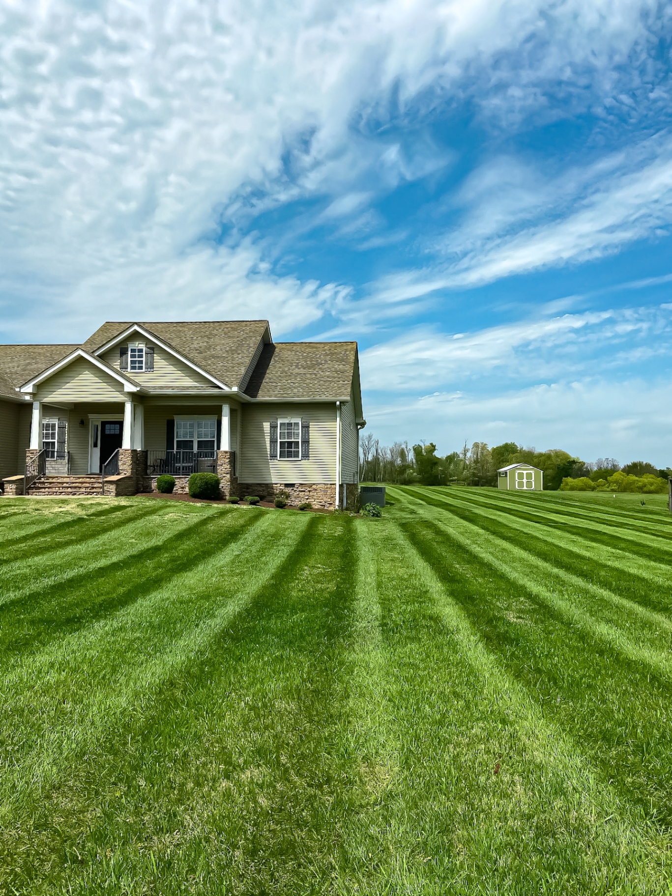 Professional lawn striping with precision mowing patterns at Tennessee residential estate by Prestige Landscape