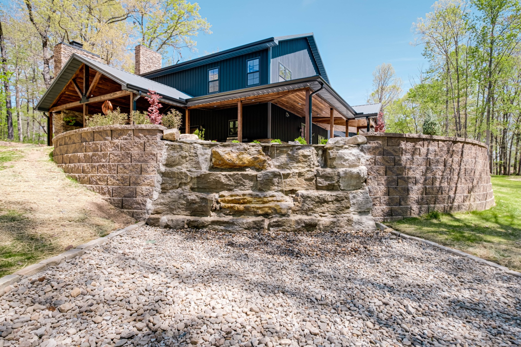 Custom retaining wall with waterfall and outdoor living area built by Prestige Landscape in Tennessee