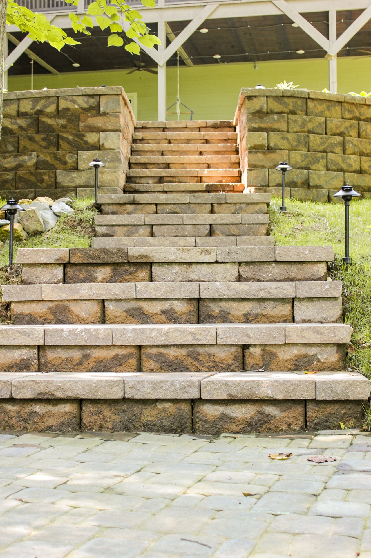 Custom stone block steps with landscape lighting and paver patio hardscape installation in Tennessee by Prestige Landscape