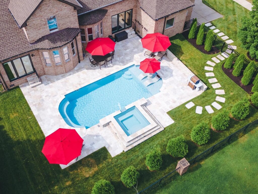 A beautifully designed outdoor living space in Nashville, featuring a custom pool, and lush greenery. Perfect for entertaining and adding value to your home